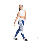 S-Line Leggings person wearing a white sports top and blue leggings with 'COUGARS' printed on the side, posing with one hand on her hip.