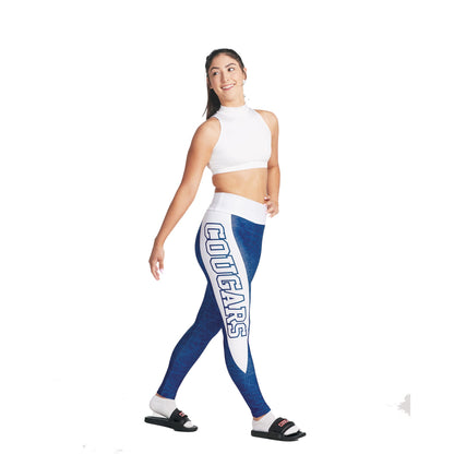 S-Line Leggings person wearing a white sports top and blue leggings with 'COUGARS' printed on the side, posing with one hand on her hip.